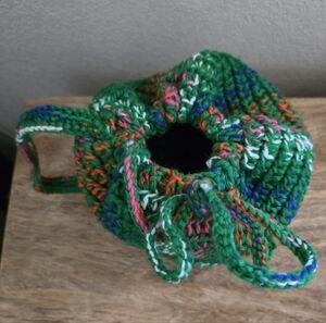 Colorful handmade crochet drawstring bag with strap, medium size.